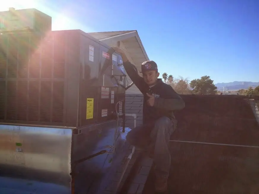 HVAC technician performing HVAC Inspection on a rooftop unit in Breaux Bridge